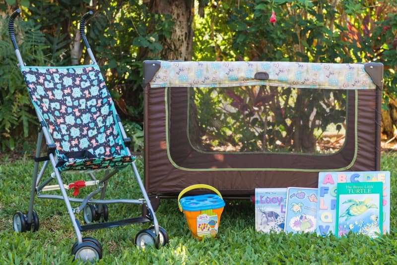 Baby gear by Maui vacation rental company Coconut Condos - stroller, playpen, baby books, puzzles, and sand toys